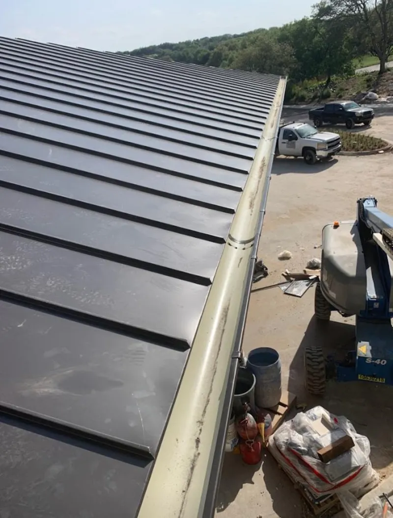 Standing seam panel and gutter detail on a metal roofing jobsite in Shreveport